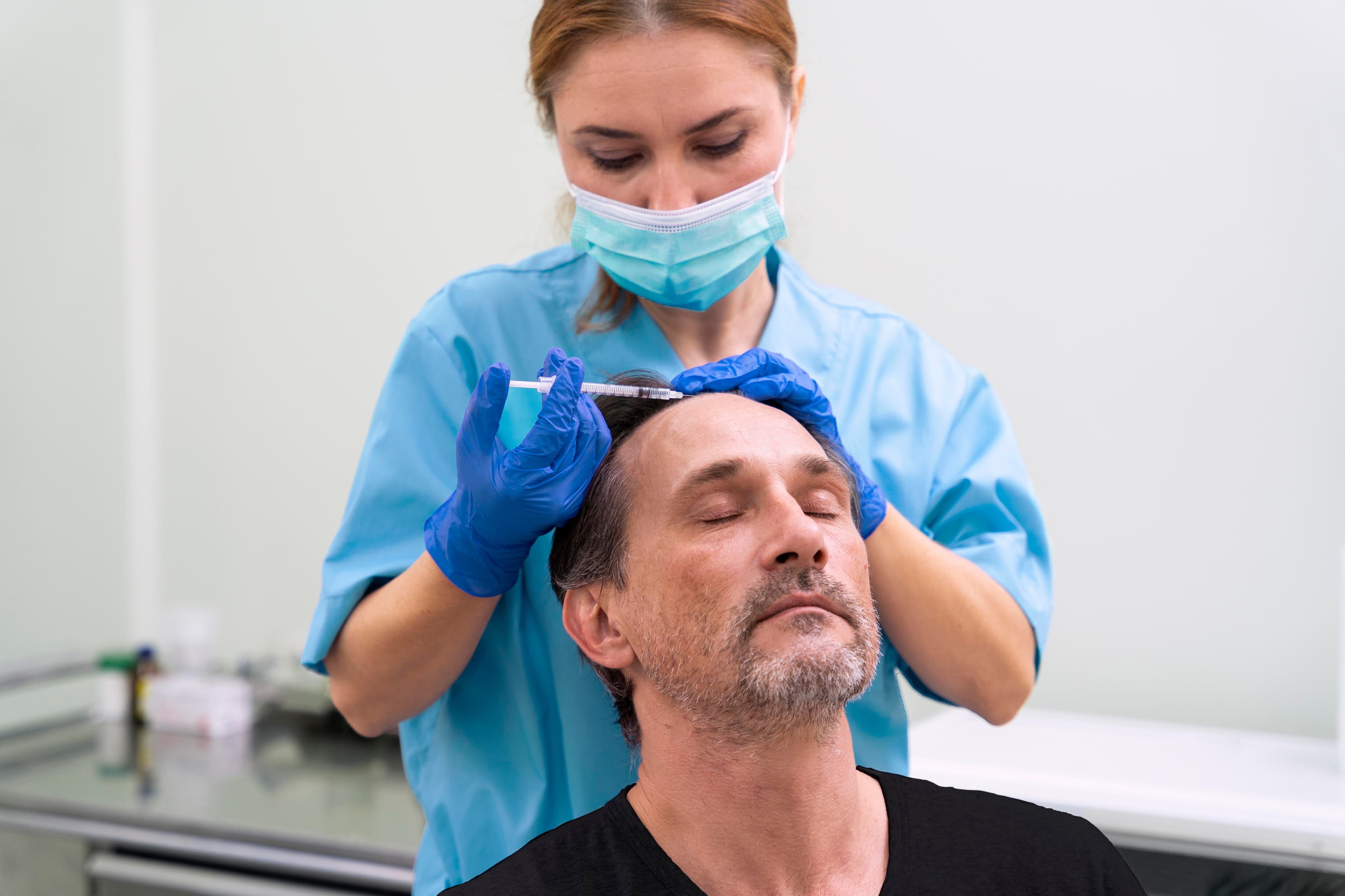 Practitioner performing a scalp treatment